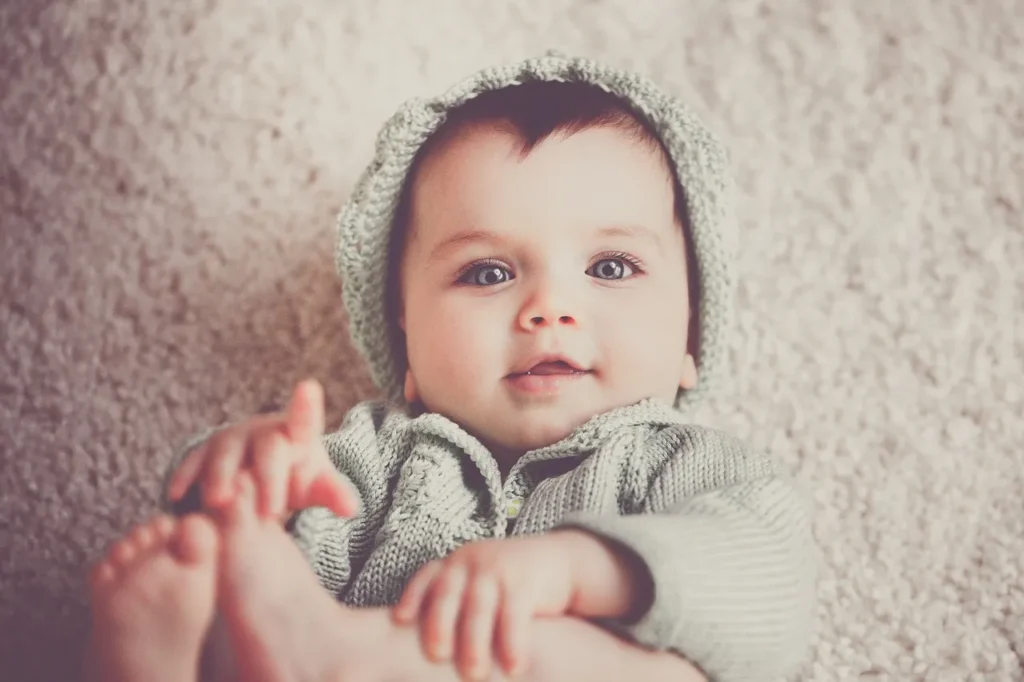 A toddler lying on the floor.